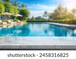 white marble top with blurred empty Swimming pool background can be used for mocking up or display product to make advertising.