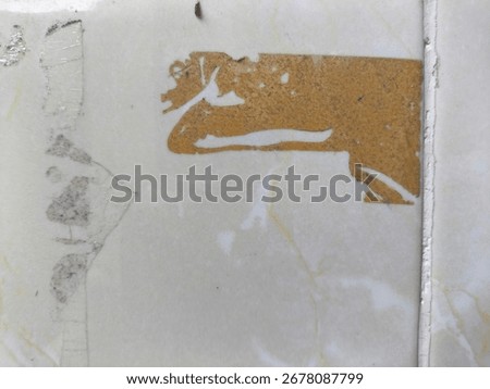 White marble wall tile with a torn adhesive patch and smudges near a grout line. Clean neutral texture for interior repair documentation and material studies.
