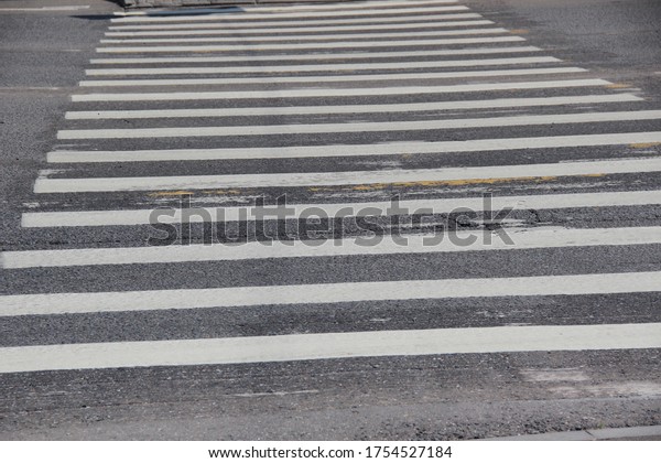 White marking of a pedestrian crosswalk. Place\
where the roadway crosses