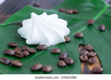 White Marshmellow, Coffee Beans On Green Leaf And Wood