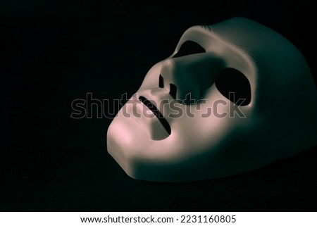 A white mask on a black background is the symbol of the attacking hacker group, this mask is a well-known symbol for anonymous online hacktivist group.copy space.