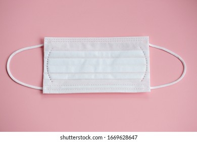 White Mask On Pink Background