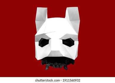 A White Mask Is Worn Over A Black Skull On A Red Background. Stylish And Beautiful White Animal Mask With Ears On A Red Background. Mask Of A Wolf, Fox, Dog, Cat.