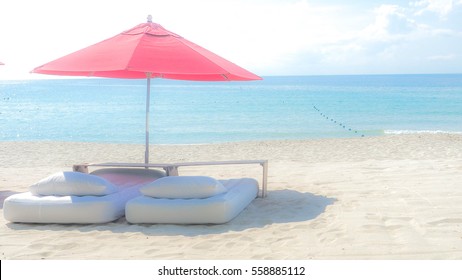 White Mattress And Red Umbrella On The Beach