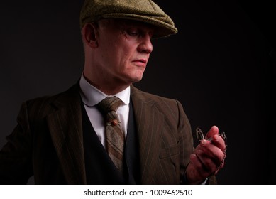 White Mature Male, Gangster Type, Dressed In 1940s Fashion Looking At His Watch.