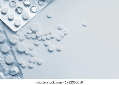 White medical template with space for text. Pile of pills in blister packs and loose. Uncontrolled medication use. Drug abuse, dependence, overdose. Opioids, tranquilizers.
