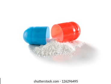 White medicament powder from open capsule isolated on the white