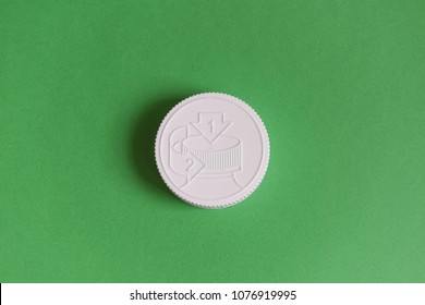 White Medicine Bottle Cap Child Proof On Green Background. Medicine And Health Concept.