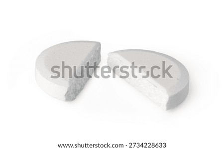 White medicine tablet split in two pieces for adjusting dosage