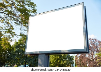 White Mega-Light Digital Poster Billboard Mock-Up Template In A City As Outdoor Advertising