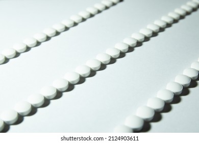 White Melatonin Pills Lined Up In A Row