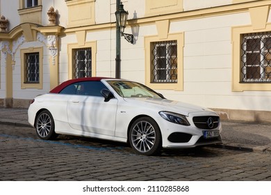 A White Mercedes C Class Convertible With A Red Roof, Parked Next To A Session Tenement House In The Old Town Of Prague. Front View. Prague, Czech Republic, 01.30.2017