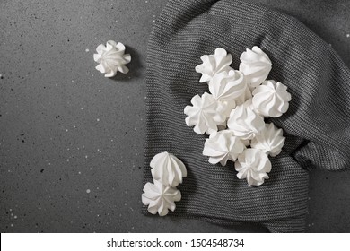 White Meringue On A Black Tea Towel. French Dessert. On The Grey Table