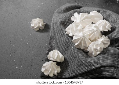 White Meringue On A Black Tea Towel. French Dessert. On The Grey Table