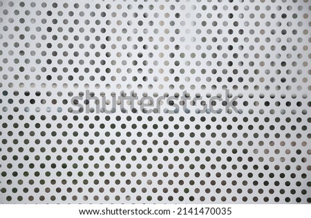  white metal background with dots pattern. Grey industrial texture backdrop. Light silver metal background with round hole.