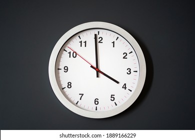 White Metal Clock On Black Wall