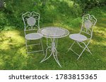 White metal yard table and two chairs.