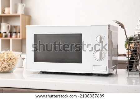 White microwave oven on counter in kitchen