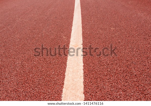 a white middle dividing line on an asphalt road
painted by red paint
