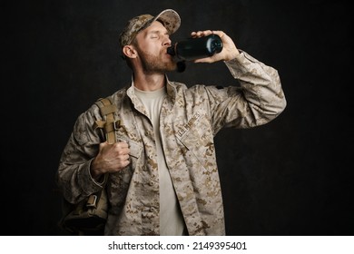 White Military Man Wearing Uniform Drinking Water From Flask Isolated Over Black Wall