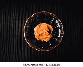 White Miso Paste On A Dish Over A Black Background.