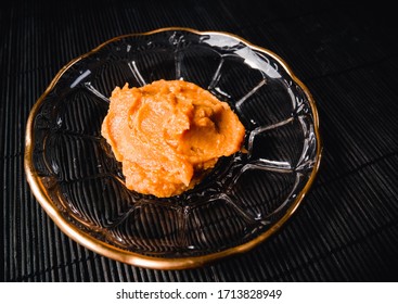 White Miso Paste On A Dish Over A Black Background.