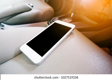 White Mobile Phone On The Car Seat - Phone At Leather Seat Of Car