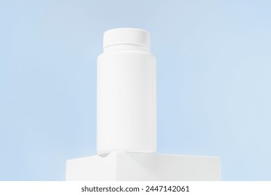 White mockup of a jar of pills or tablets on a blue isolated background. The concept of dietary supplements for men's health, pharmacy, vitamins. Image for your design