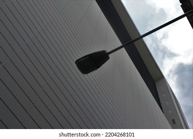 White Modern Building Covered In Streetlight Silhouette