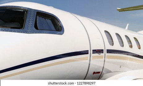 White Modern Business Jet Plane Entrance Door And Cockpit Windows Close Up.