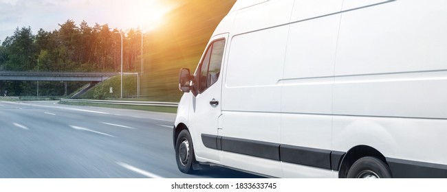 White modern delivery small shipment cargo courier van moving fast on motorway road to city urban suburb. Busines distribution and logistics express service. Mini bus driving on highway day. banner - Shutterstock ID 1833633745