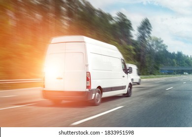 White Modern Delivery Small Shipment Cargo Courier Van Moving Fast On Motorway Road To City Urban Suburb. Business Distribution And Logistics Express Service. Mini Bus Driving On Highway On Sunny Day