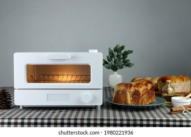 white modern design toaster oven , countertop or convection oven is on the table with homemade sweet potato butter toast breads on grey cement wall background in the kitchen room for breakfast - Shutterstock ID 1980221936