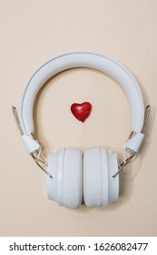 White modern headphones, listening music 