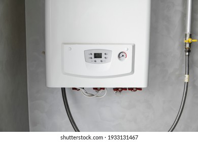 White Modern Home Gas Boiler Mounted On A Grey Wall On A Kitchen. Water Heater. Water Heating, Ecology.