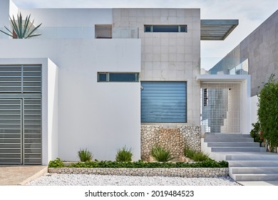 a white modern home on an island - Shutterstock ID 2019484523