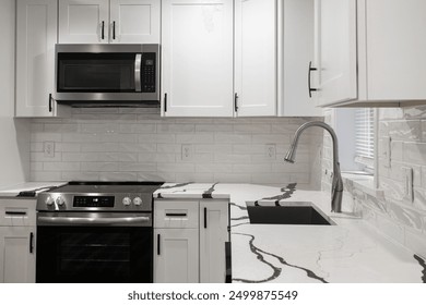 White Modern Kitchen With Stainless Steel Appliances And Ample Natural Light - Powered by Shutterstock