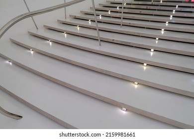 White Modern Staircase In A Building With Lights And Parapet. Interior Design. 