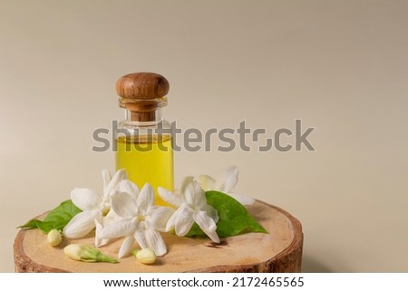 White mogra or arabian jasmine or Jasminum sambac flower Buds Essential oil in glass bottle beauty treatment. 