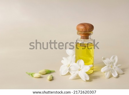 White mogra or arabian jasmine or Jasminum sambac flower Buds Essential oil in glass bottle beauty treatment.