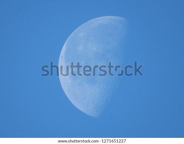 white moon in blue
sky