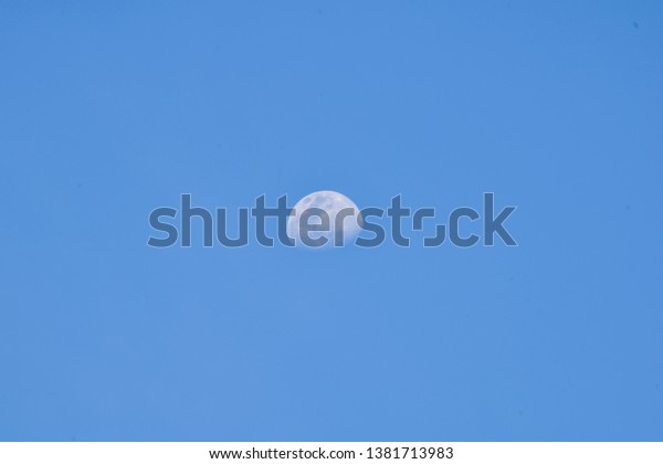White moon in the blue sky\
before sunset, The moon rose at Early Evening, Beautiful nature\
background.