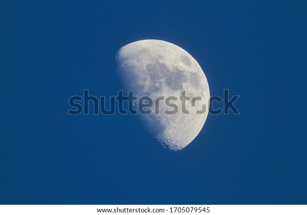 White moon in a blue sky,\
macro