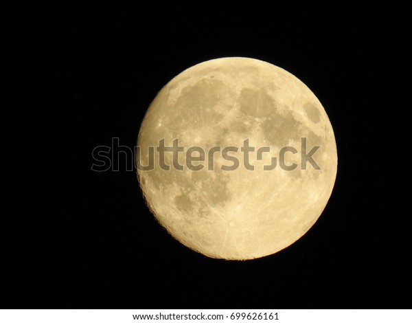 White moon\
close-up photography. Black background.  You can see craters on the\
moon\'s surface. The beauty of\
nature.