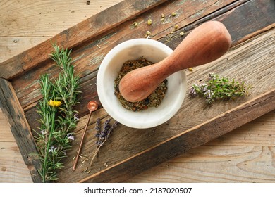 White Mortar With Wooden Pestle With Fresh And Dried Herbs On Old Wooden Tray, Overhead Shot