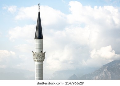 White mosque minaret. Mosque minaret with clouds in the background in Turkey - Powered by Shutterstock