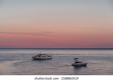 White Motor Yacht And Cruise Liner At Sea On Summer Evening At Sunset