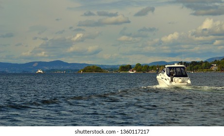 White Motorboat Traveling Around Oslo Fjord, Oslo Norway. Motor Boat On A Way To Islands Of Oslofjord. Scenic Landscape.