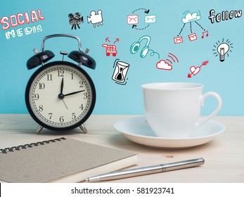 White mug  and clock on wooden table over grunge background.Concept coffee break or tea time. Create idea from copy space on color background.