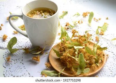 White mug with linden flower tea. Dried linden flowers.Selective Focus
